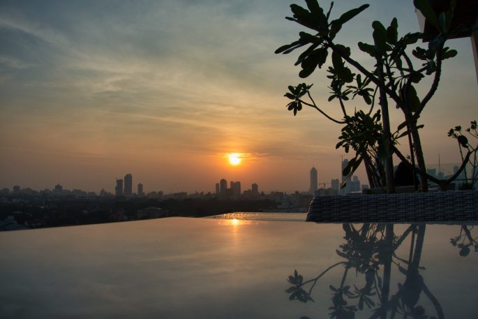 Sunset over the infinity pool at Jetwing Colombo Seven's rooftop pool