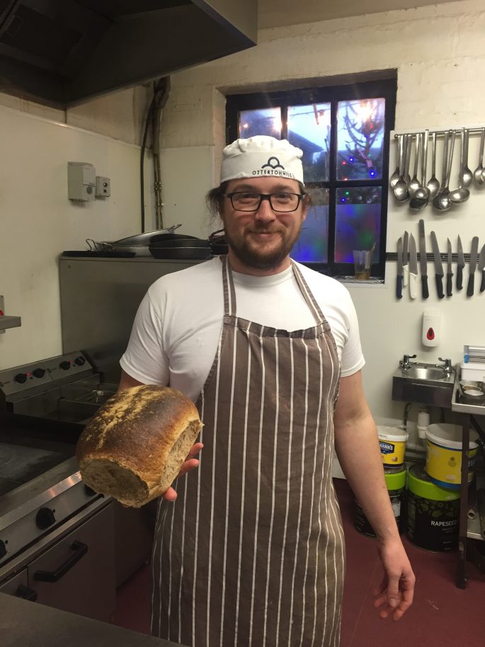 Baker Zac with one of the mill's wholemeal loaves